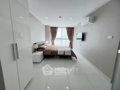 Modern bedroom with sleek design, featuring a comfortable bed, air conditioning, and stylish decor.