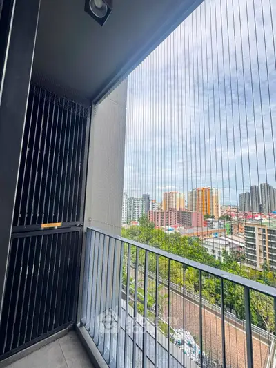 Spacious balcony with stunning city view in modern high-rise apartment