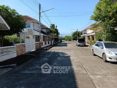 Charming suburban street with modern houses and parked cars, ideal for family living.