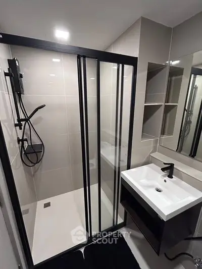 Modern bathroom with sleek shower and stylish sink in contemporary design.