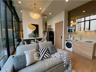 Modern living room with open kitchen, stylish decor, and large windows in a chic apartment.