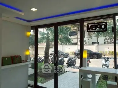 Modern entrance with glass doors and street view, ideal for commercial space.