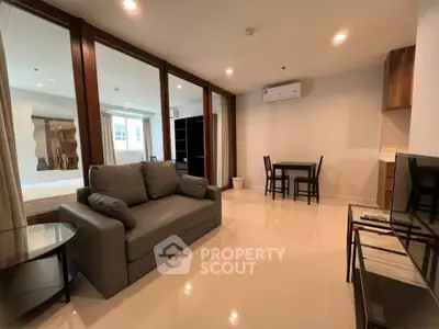 Modern living room with sleek furniture and open layout in a stylish apartment.