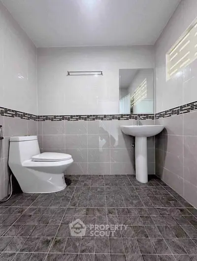 Modern bathroom with sleek design and tiled flooring