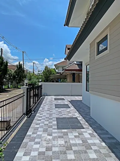 Charming residential exterior with tiled pathway and modern design