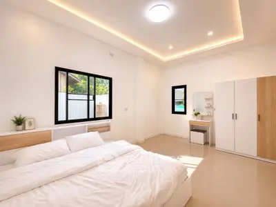 Spacious modern bedroom with natural light and minimalist design