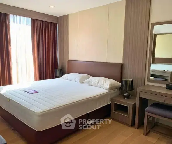 Spacious bedroom with modern decor and natural light