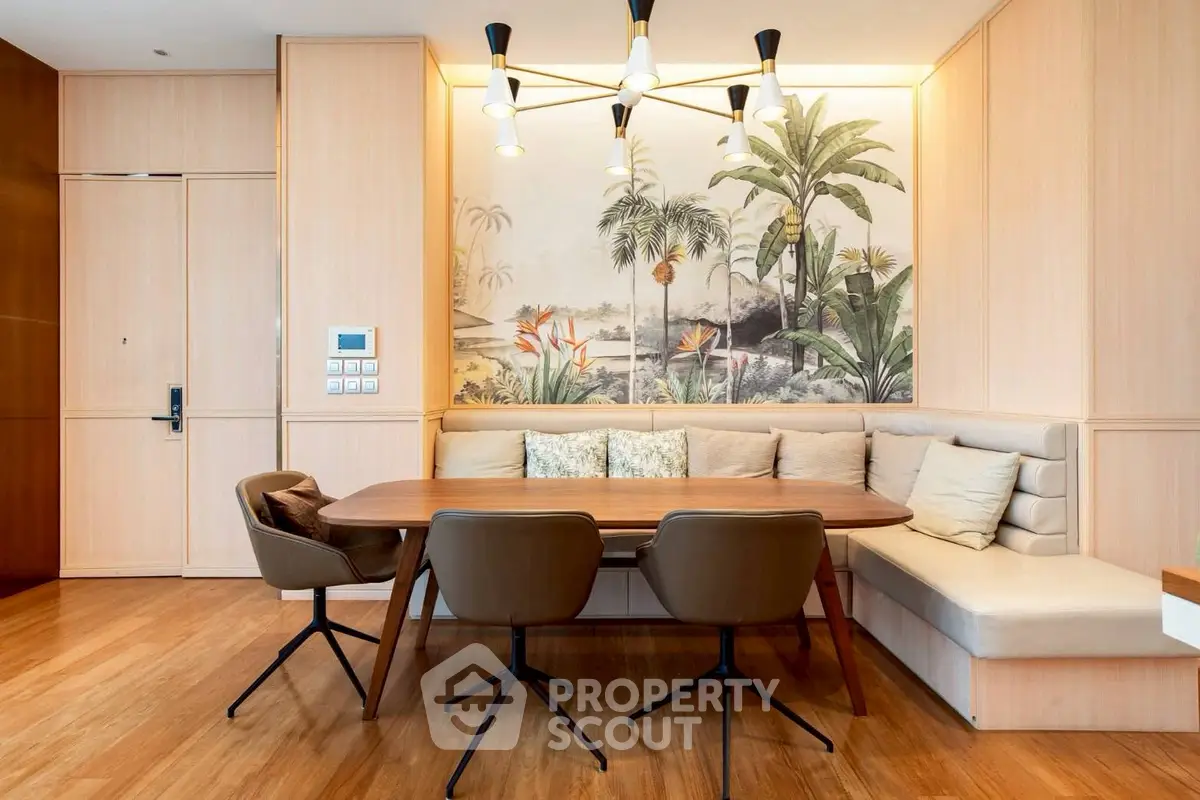 Elegant dining area with stylish lighting and tropical wall art in modern apartment.