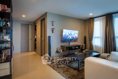 Modern living room with stylish decor and wall-mounted TV, perfect for relaxation and entertainment.