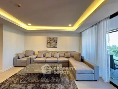 Modern living room with stylish gray sectional sofa and elegant lighting