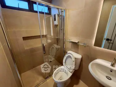 Modern bathroom with glass shower enclosure and sleek fixtures