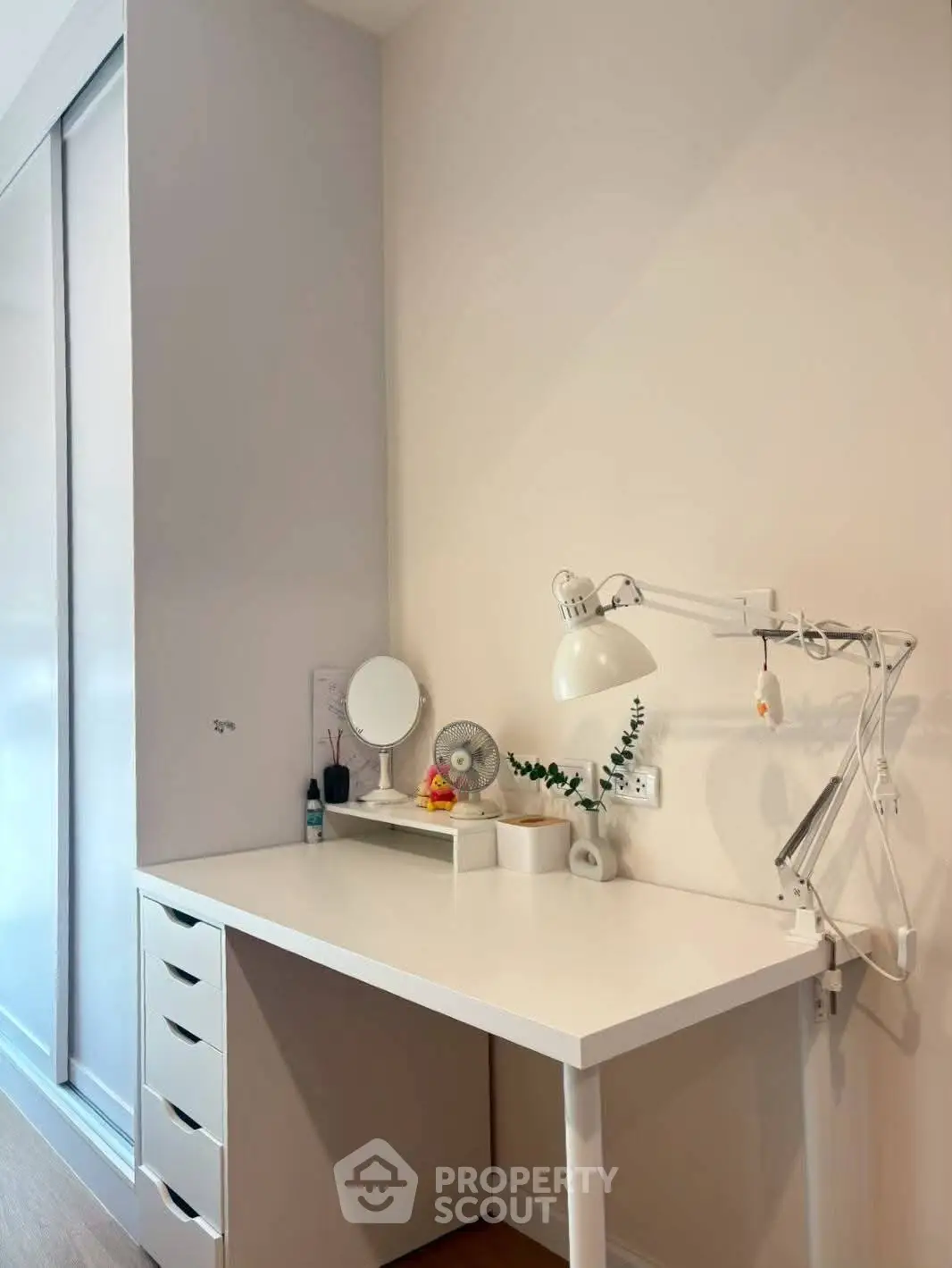 Modern study area with sleek white desk and lamp, perfect for productivity.