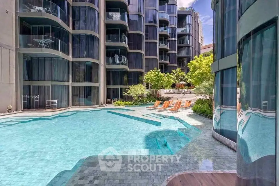 Luxurious modern apartment complex with stunning pool and elegant architecture.