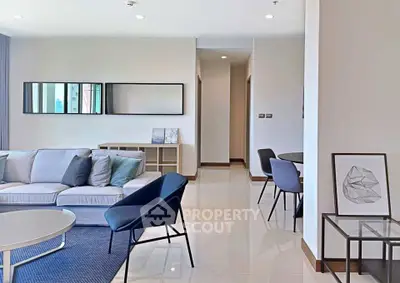 Spacious modern living room with elegant furniture and stylish decor in a contemporary apartment.