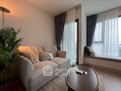 Cozy living room with modern decor and large windows offering city views.