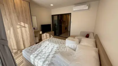 Modern bedroom with wooden wardrobe and air conditioning in a cozy apartment