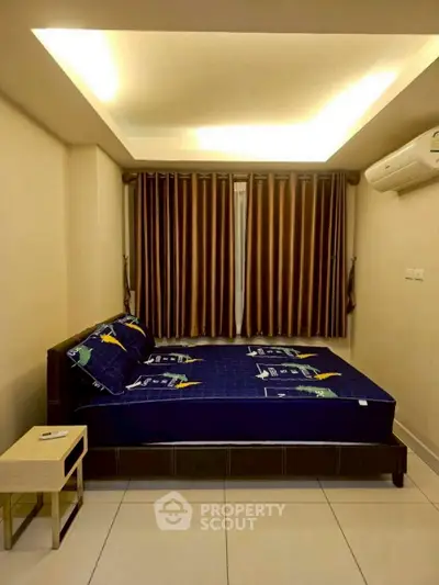 Cozy bedroom with modern lighting and air conditioning, perfect for relaxation.