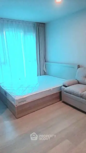 Cozy bedroom with natural light and comfortable furnishings