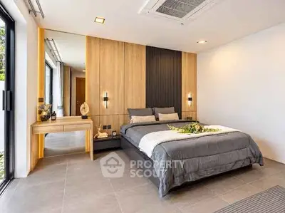 Luxurious modern bedroom with elegant decor and large windows for natural light.