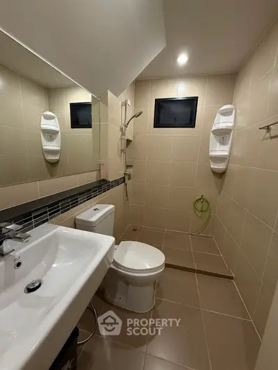 Modern bathroom with sleek fixtures and neutral tiles