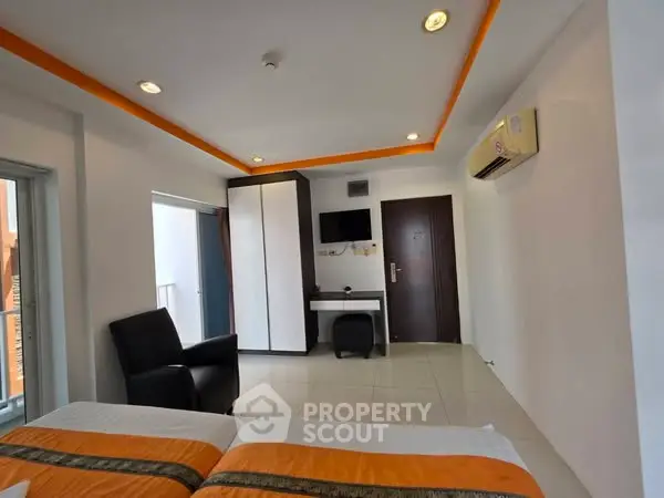 Modern bedroom with sleek design, featuring air conditioning and stylish furniture.