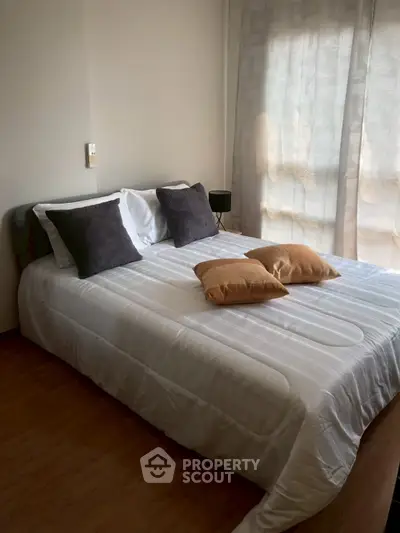 Cozy bedroom with stylish decor and natural light
