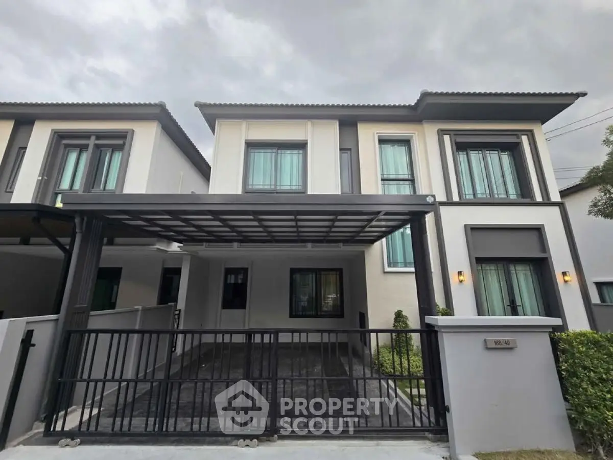 Modern two-story house with sleek design and gated driveway