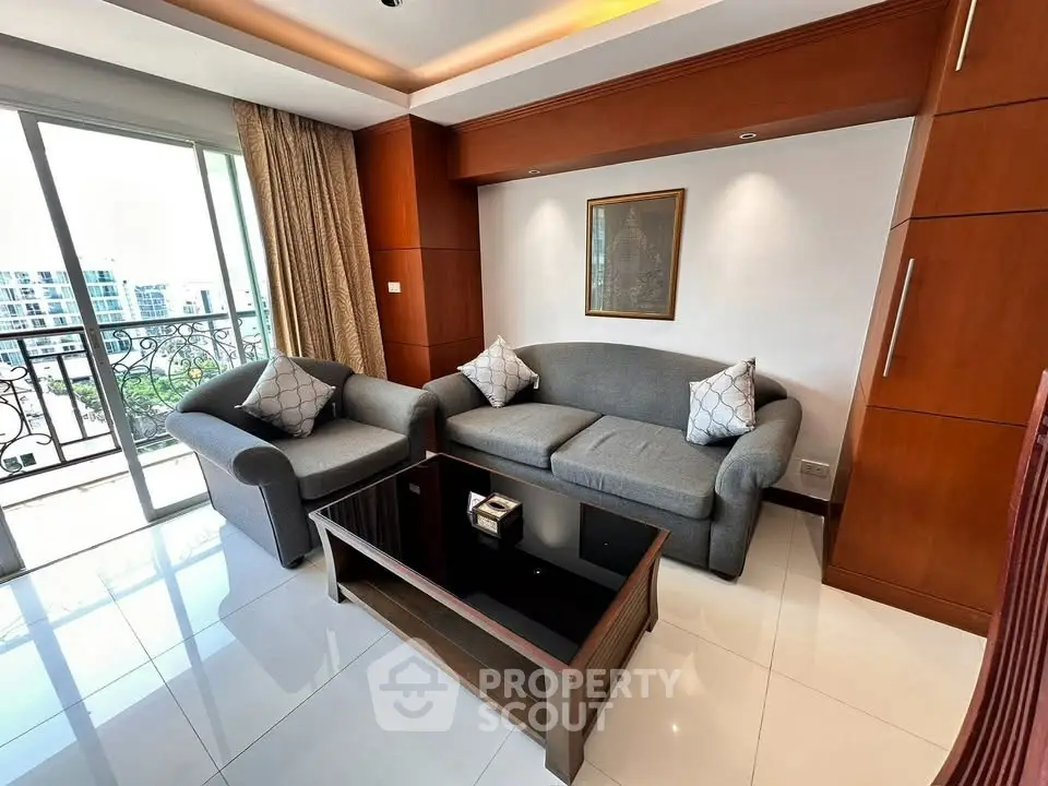 Stylish living room with modern furniture and balcony view in urban apartment.