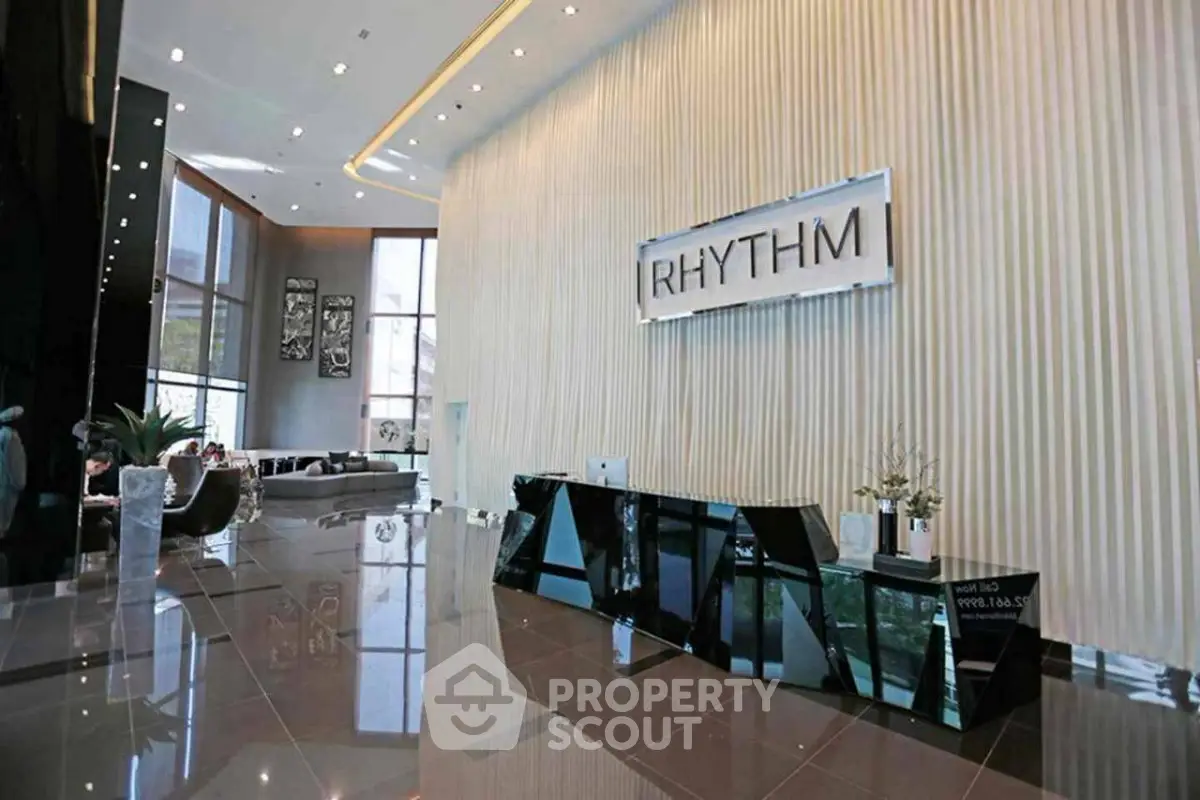 Luxurious modern building lobby with sleek design and elegant decor, featuring high ceilings and stylish furnishings.