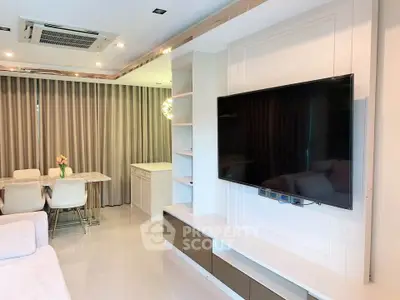 Modern living room with wall-mounted TV and elegant dining area in open layout.