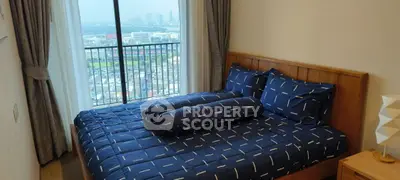Cozy bedroom with city view and stylish bedding in modern apartment