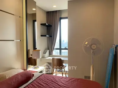 Cozy bedroom with city view, featuring a study nook and modern decor, perfect for urban living.