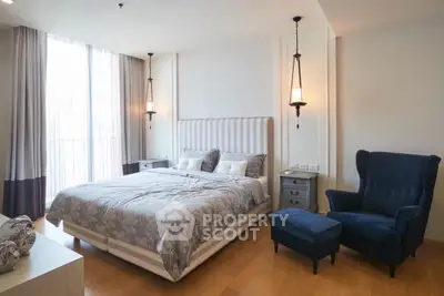 Elegant bedroom with modern decor and cozy armchair in luxury apartment