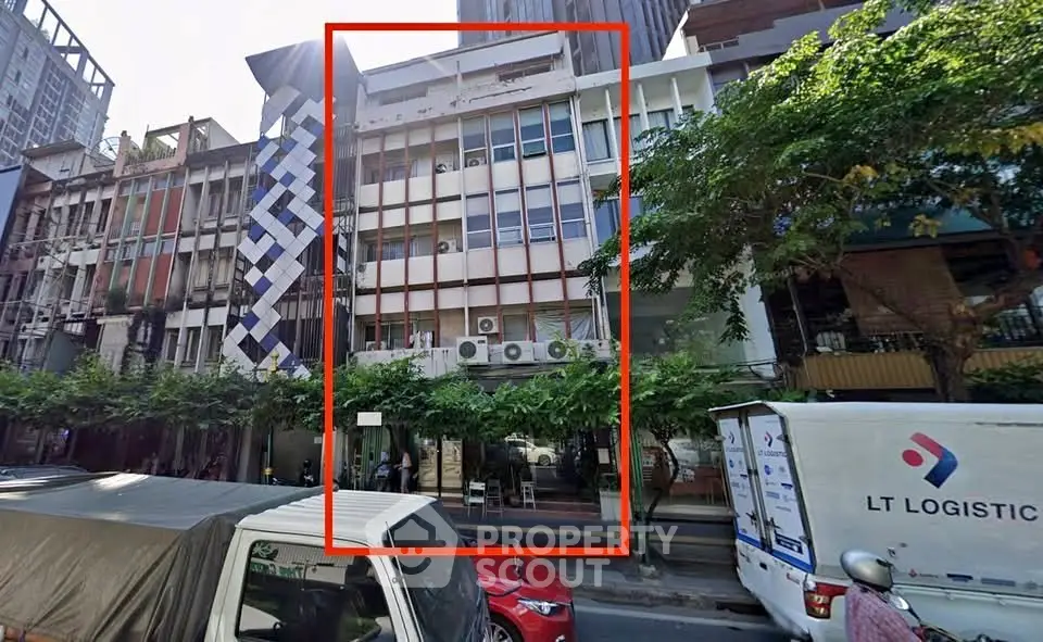 Commercial building exterior with modern facade and street view in urban setting.