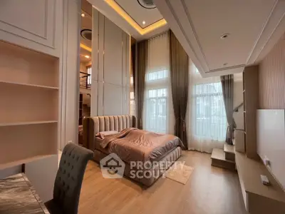 Luxurious bedroom with high ceilings and elegant decor, featuring a plush bed and large windows for natural light.