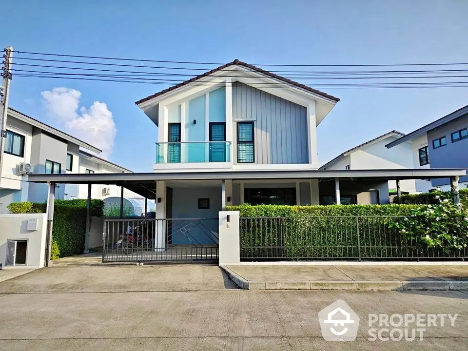 Modern two-story house with spacious driveway and well-maintained garden in a serene neighborhood.