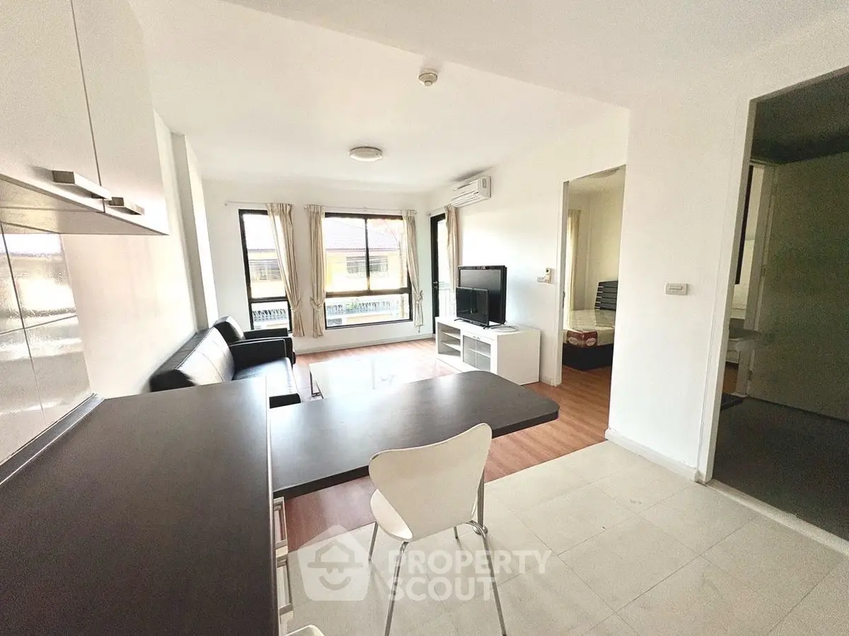 Modern open-plan living room with sleek furniture and natural light