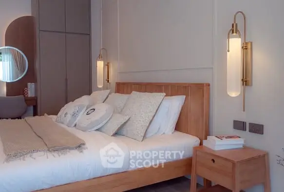 Elegant bedroom with modern lighting and cozy wooden furniture