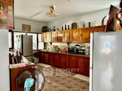 Spacious kitchen with wooden cabinets and modern appliances