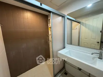 Modern bathroom with sleek sink and spacious shower area