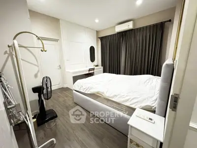 Cozy bedroom with modern decor and ample natural light