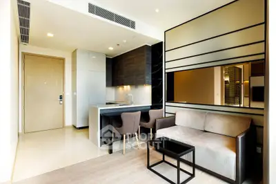Modern open-layout living room with sleek kitchen and stylish furniture in a contemporary apartment.