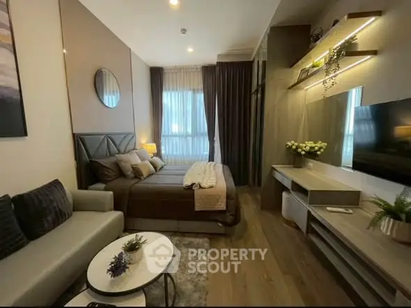 Luxurious modern bedroom with elegant decor and cozy seating area, perfect for relaxation.