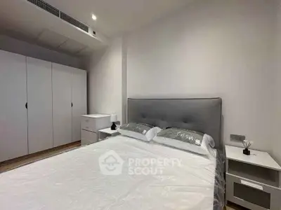 Modern bedroom with sleek design and ample storage in a stylish apartment.