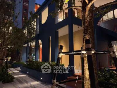 Stunning modern building exterior with lush landscaping and ambient lighting at dusk.