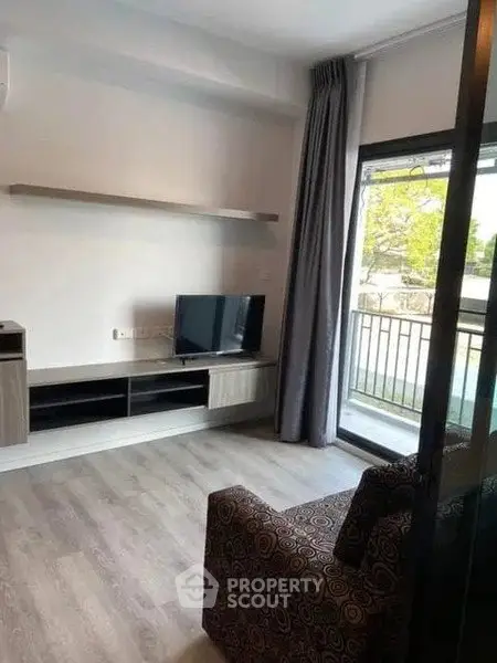 Modern living room with balcony access and stylish decor