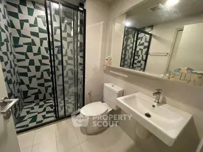Modern bathroom with geometric tile shower and sleek fixtures