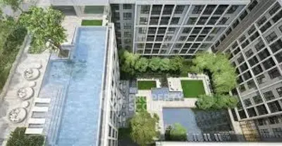 Stunning aerial view of modern apartment complex with rooftop pool and lush gardens.