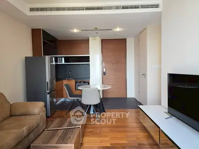 Modern living room with sleek furniture and open kitchen layout