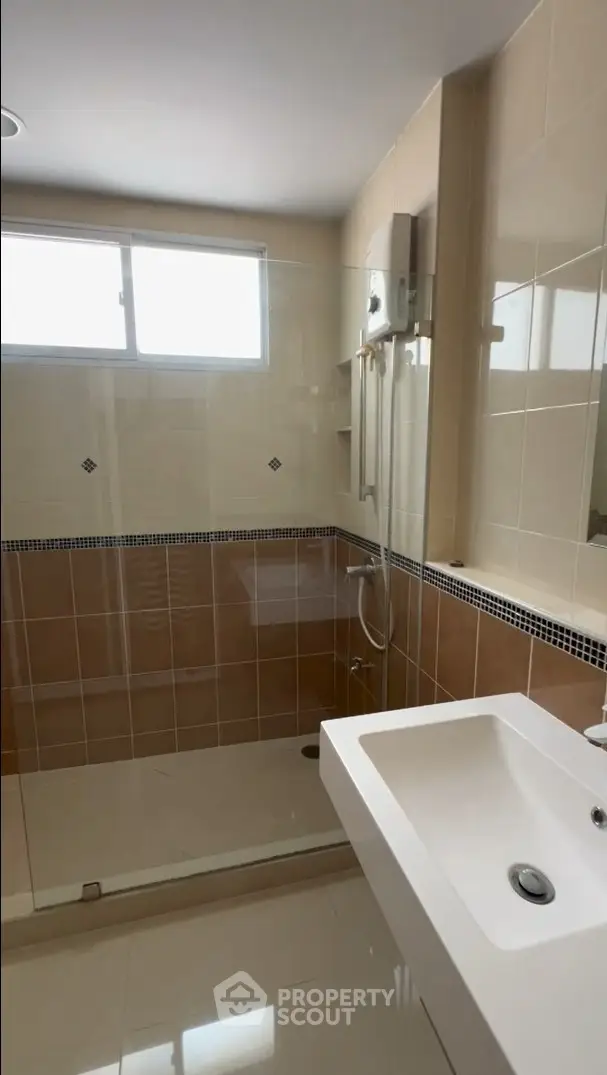 Modern bathroom with glass shower and sleek sink design